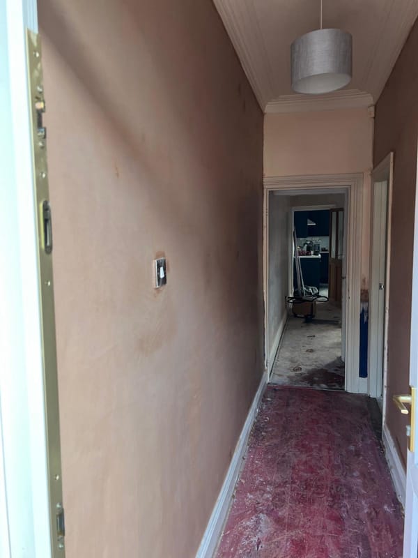 Brick wall undergoing damp proofing treatment by Moorlands Plastering